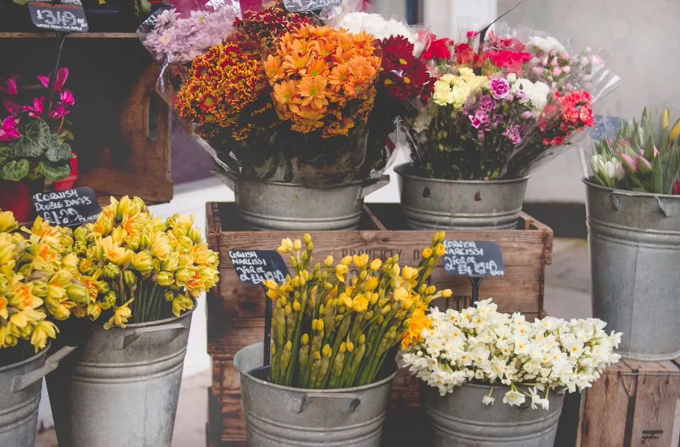 Buckets of cut flowers on display outside a flower shop