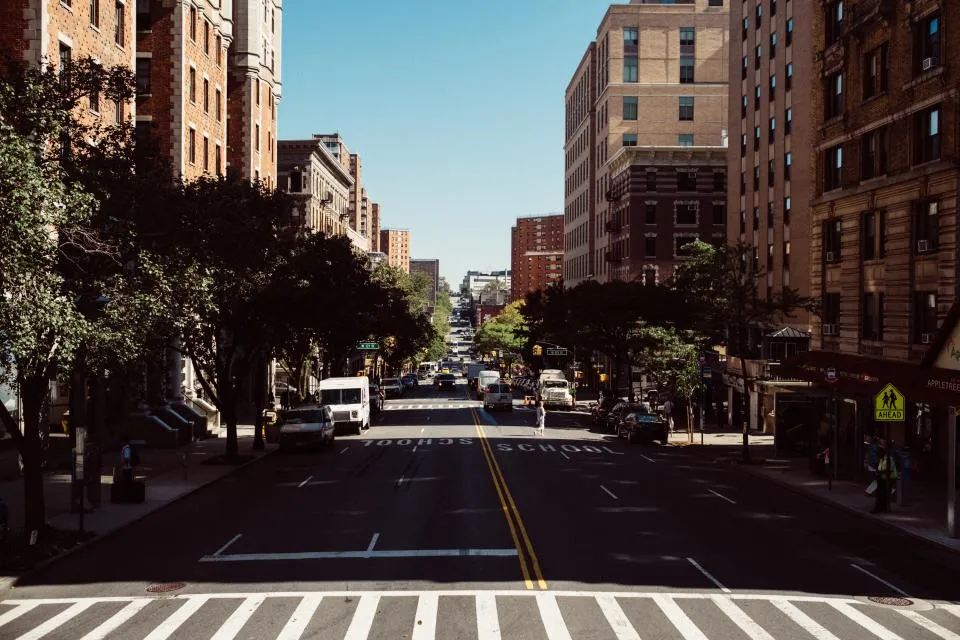 City avenue with delivery vans and box trucks in traffic